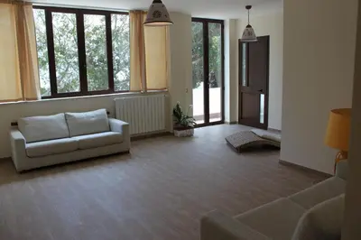 a living room with a couch and some windows at Locanda Del Drago in Monreale