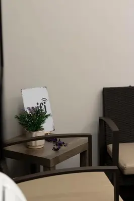 a table with a bottle of wine and bowls of food at Dea Suite in Bagheria