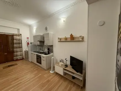 a room with a bed and a painting on the wall at monteleone centro apartment in Palermo