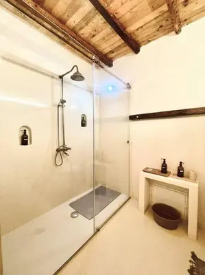 a bathroom with a shower with a glass door at Duplex Townhouse with Gigantic Terrace in Palermo