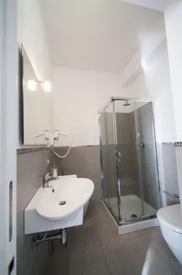a bathroom with a sink and a glass shower at B&b Diamond in San Vito lo Capo