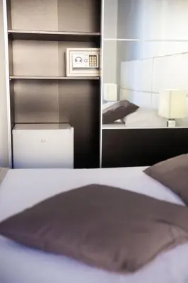 a bedroom with a white bed and a mirror at B&b Diamond in San Vito lo Capo