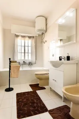 a white bathroom with a toilet and a sink at Casa Vacanze La Dolce Vita in Terrasini