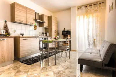 a kitchen with a table and chairs in a room at Casa Vacanze La Dolce Vita in Terrasini