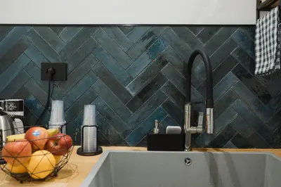 a kitchen sink with a bowl of fruit on a counter at Butera 505-Luxury Suites in Bagheria