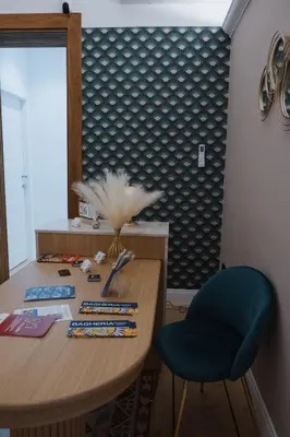 a dining room table with a blue chair next to a wall at Butera 505-Luxury Suites in Bagheria