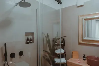 a bathroom with a glass shower and a sink at Bloom Apartment 35 in Palermo