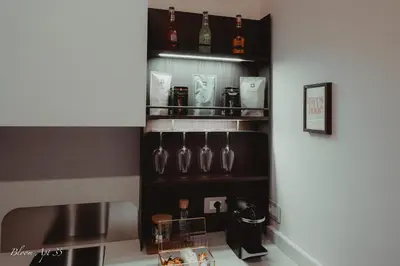 a shelf with wine glasses and a bottle on it at Bloom Apartment 35 in Palermo