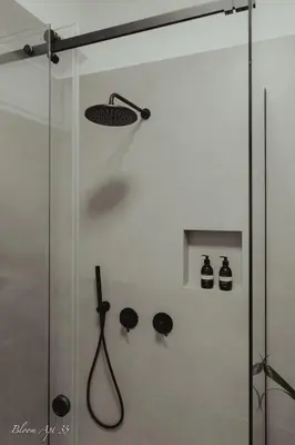 a shower with a glass door with a shower head at Bloom Apartment 35 in Palermo