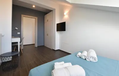 a bedroom with a blue bed with towels on it at Amazing Home In Balestrate With Wifi in Balestrate