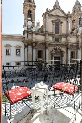 two chairs and a table in front of a building at Olivella 11 in Palermo
