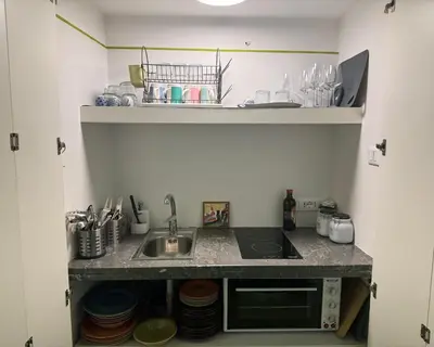 a kitchen with a sink and a counter top at Olivella 11 in Palermo