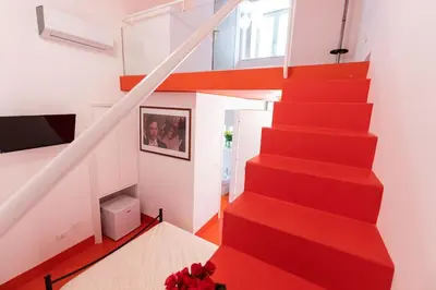 a red staircase in a house with a red carpet at Olivella 11 in Palermo