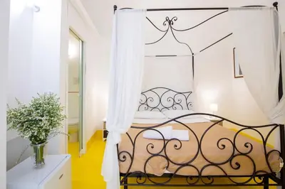 a bedroom with a black and white bed at Olivella 11 in Palermo