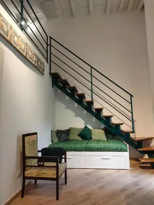 a bedroom with a green bed and a staircase at Liberty Green House in Palermo