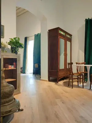 a living room with a fireplace and a table and chairs at Liberty Green House in Palermo