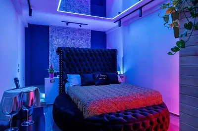 a bedroom with a bed with a black head board at D'ossuna66 Suite & Spa in Palermo
