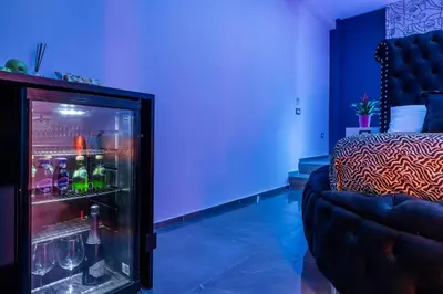 a room with a refrigerator with drinks in it at D'ossuna66 Suite & Spa in Palermo