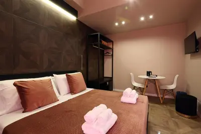 a bedroom with a bed with pink towels on it at Spera Luxury Palermo & SPA in Palermo