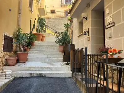a stairway with potted plants on the side of a building at Civico 22 Casa Vacanza in Torretta