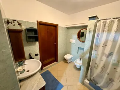 a bathroom with a sink and a toilet and a shower at Civico 22 Casa Vacanza in Torretta