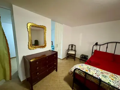 a bedroom with a bed and a dresser and a mirror at Civico 22 Casa Vacanza in Torretta