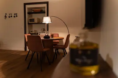 a room with a table with chairs and a lamp at Soldano luxury apartment in Palermo