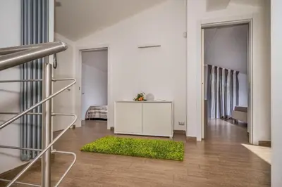 a living room with a table and a green rug at Borgo Aranci - Villa Nicales in Castellammare del Golfo