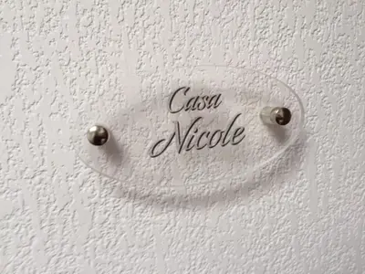 a sign on a white wall with the word casse nucleus at Casa Vacanze Nicole in Balestrate