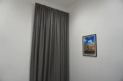 a curtain in a room with a picture on a wall at 27 Apartaments Palermo in Palermo