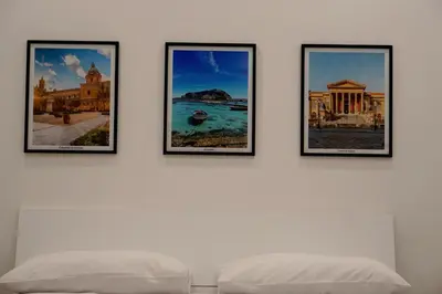 four framed pictures on a white wall at 27 Apartaments Palermo in Palermo