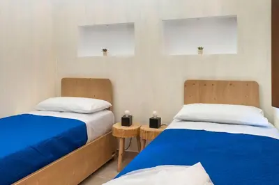 two beds sitting next to each other in a room at Villa Faraglioni Cala Bianca in Castellammare del Golfo