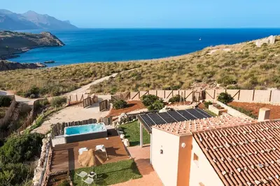 an image of a house with solar panels on the roof at Villa Faraglioni Cala Bianca in Castellammare del Golfo