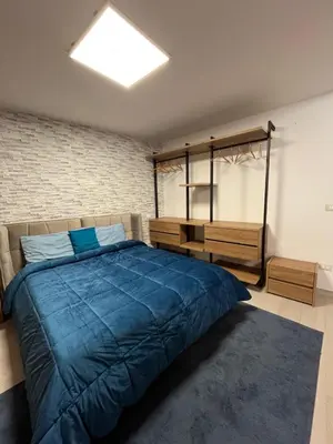 a bedroom with a large blue bed in a room at La Terrazza di Nela in Bagheria