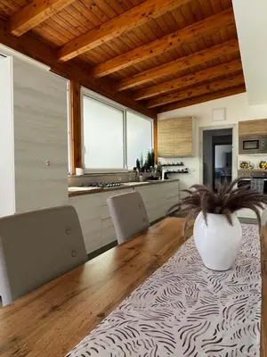 a kitchen with a table and chairs and a vase at La Terrazza di Nela in Bagheria
