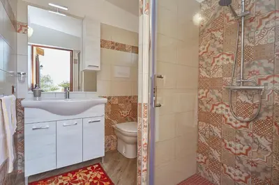 a bathroom with a sink and a toilet and a shower at Villa Ninetta in Scopello