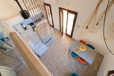 an overhead view of a dining room table and chairs at Villa Guidaloca Cala Bianca in Castellammare del Golfo