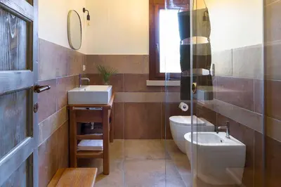 a bathroom with a toilet and a sink at Villa Guidaloca Cala Bianca in Castellammare del Golfo