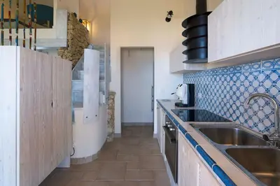 a kitchen with a sink and a counter top at Villa Guidaloca Cala Bianca in Castellammare del Golfo
