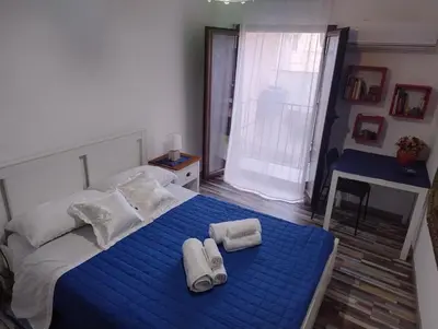 a bedroom with a blue bed with towels on it at La Casetta al Cassaro in Palermo