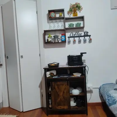 a small table in a room next to a refrigerator at La Casetta al Cassaro in Palermo