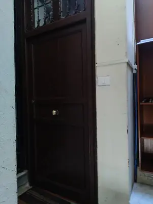 a black door with a gold door knob at La Casetta al Cassaro in Palermo