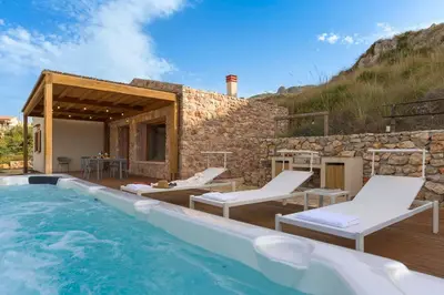 a villa with a swimming pool and a house at Villa Scogliera Cala Bianca in Castellammare del Golfo