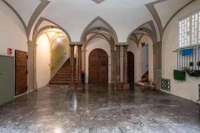 an empty hallway with arched ceilings and wooden doors at Alloro House with Terrace by Wonderful Italy in Palermo