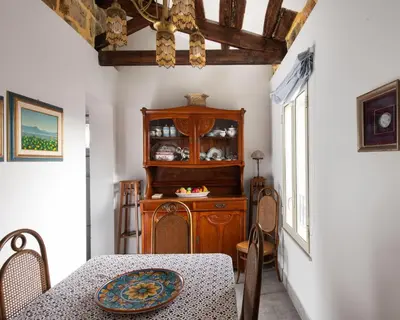 a dining room with a table and a wooden cabinet at Alloro House with Terrace by Wonderful Italy in Palermo
