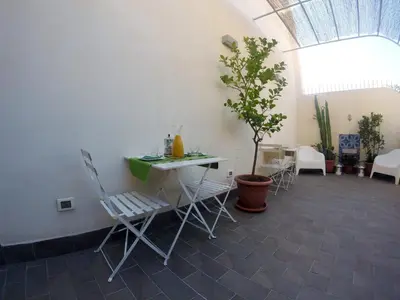 a room with chairs and a table and a tree at B&B Cannoli in Palermo