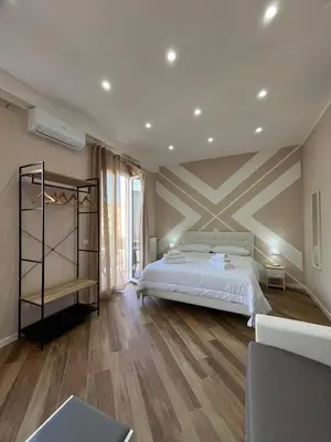 a bedroom with a bed and a striped wall at Casa Miriam 281 in Palermo