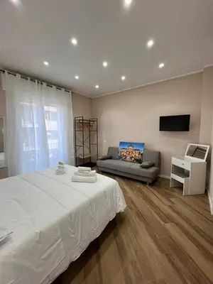a bedroom with a white bed and a couch at Casa Miriam 281 in Palermo