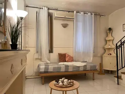 a room with a bed with a table and a window at The Tangerine's Garden in Palermo