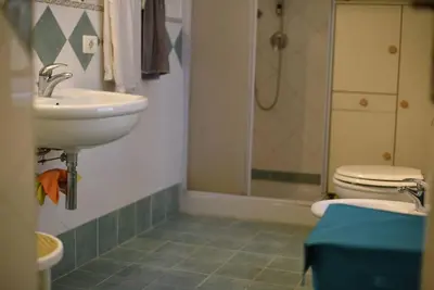 a bathroom with a sink and a toilet at The Tangerine's Garden in Palermo